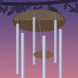 Metal wind chimes hanging from a branch at dusk